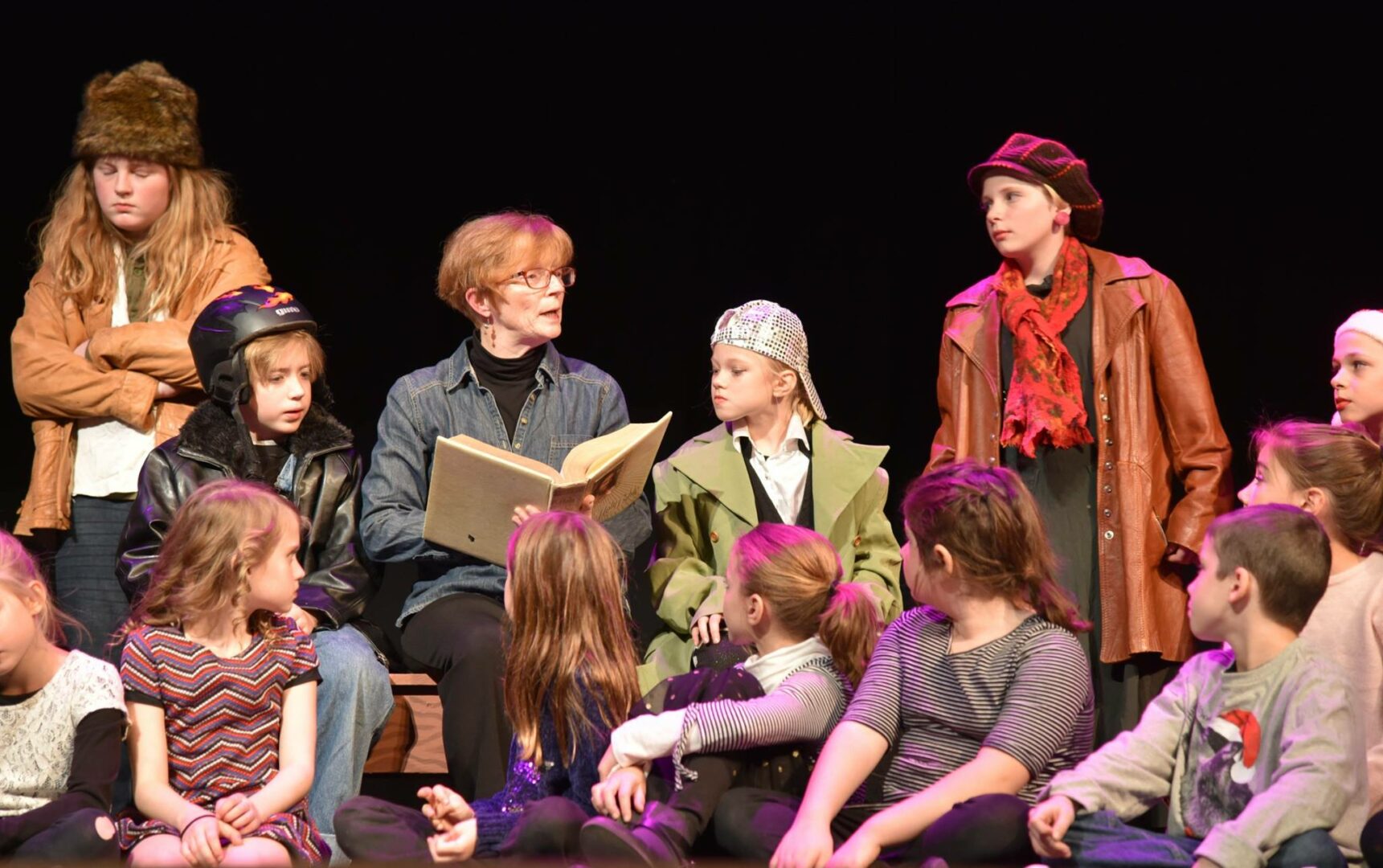 Amy reading to a group of kids during a play