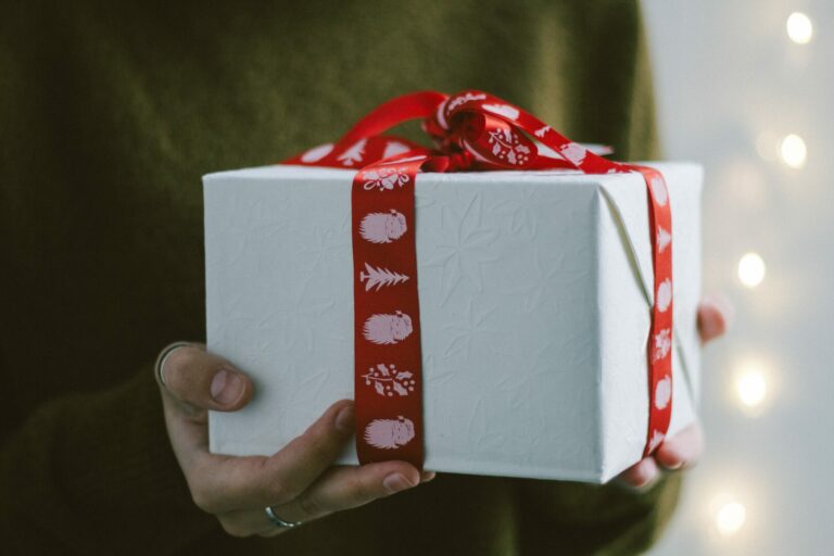 a woman holding a christmas gift