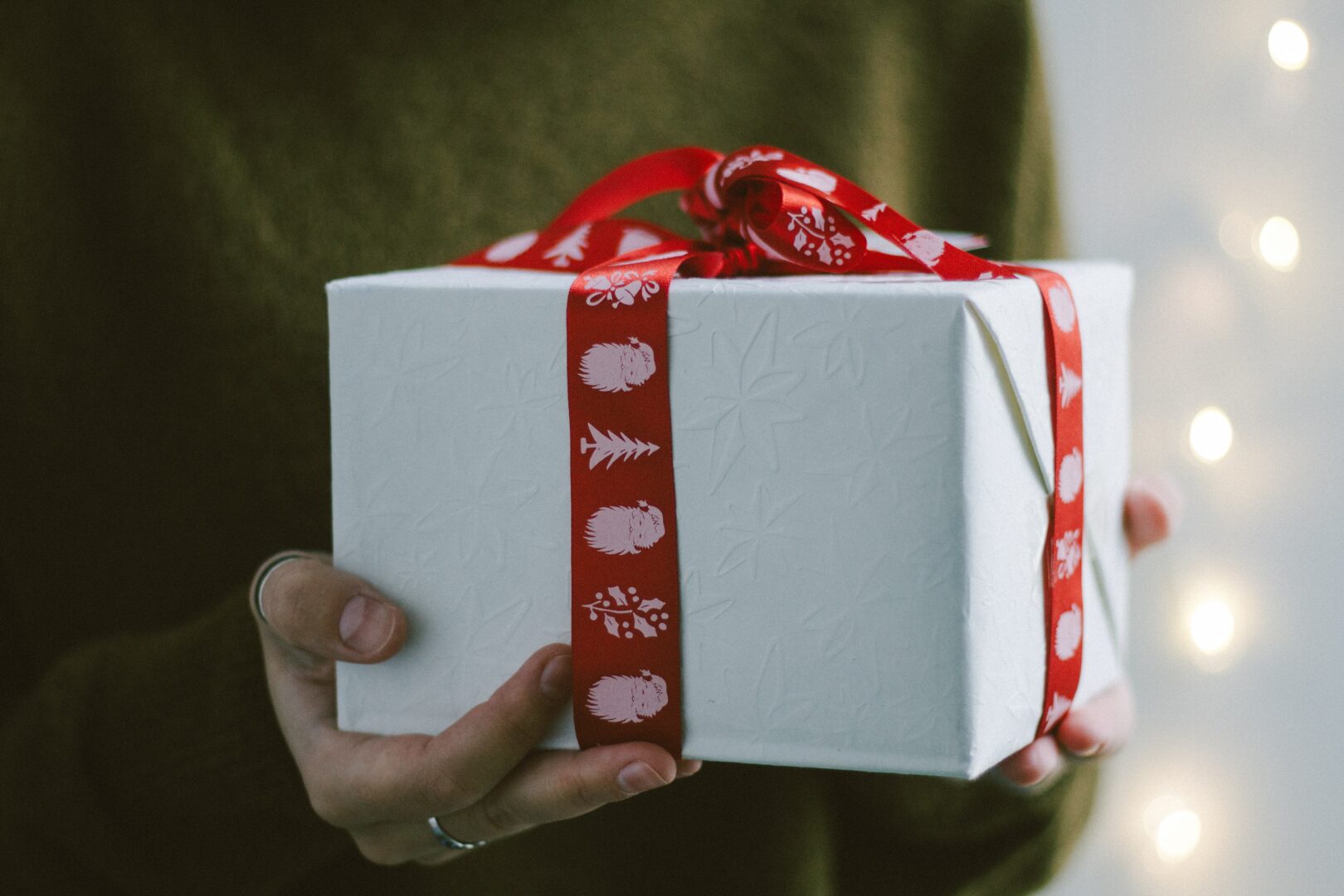 a woman holding a christmas gift